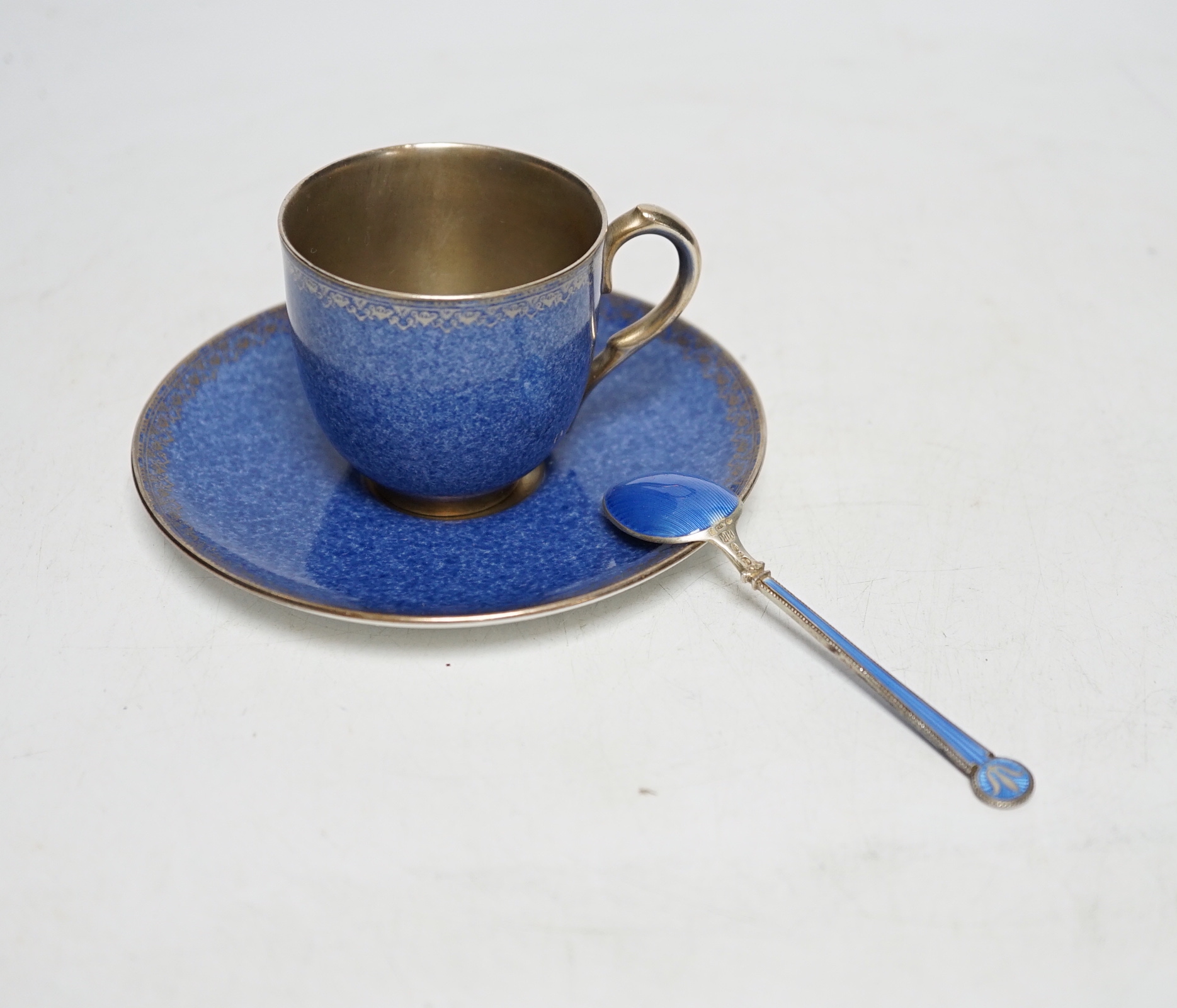 A cased Worcester powder blue and silvered coffee set with enamelled silver spoons together with a cased set of six green and frosted glass salts